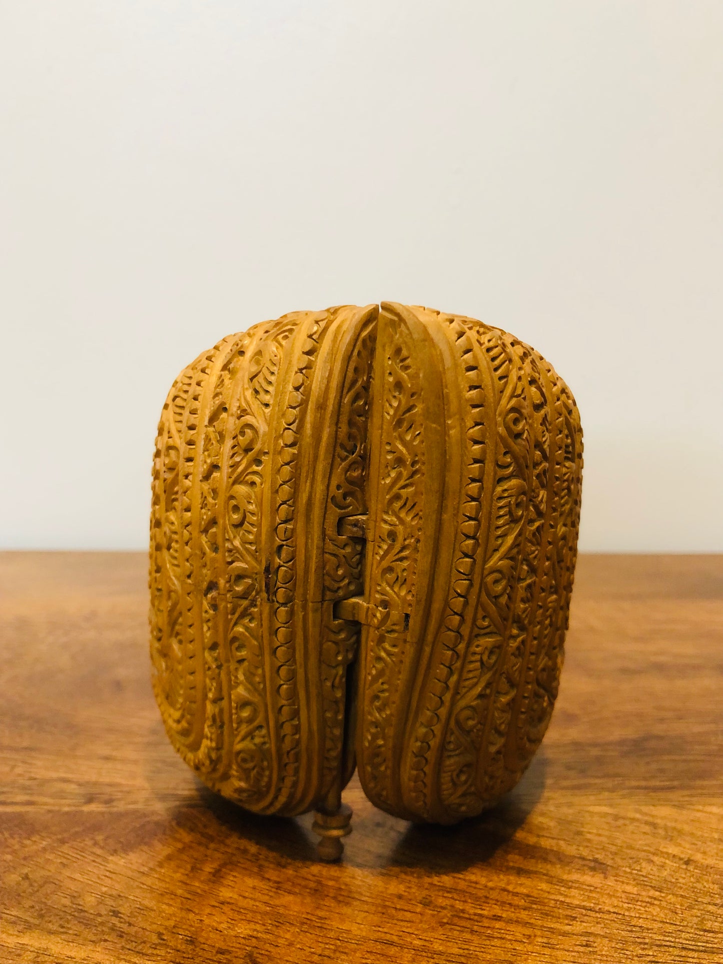 Sandalwood carved god inside shell