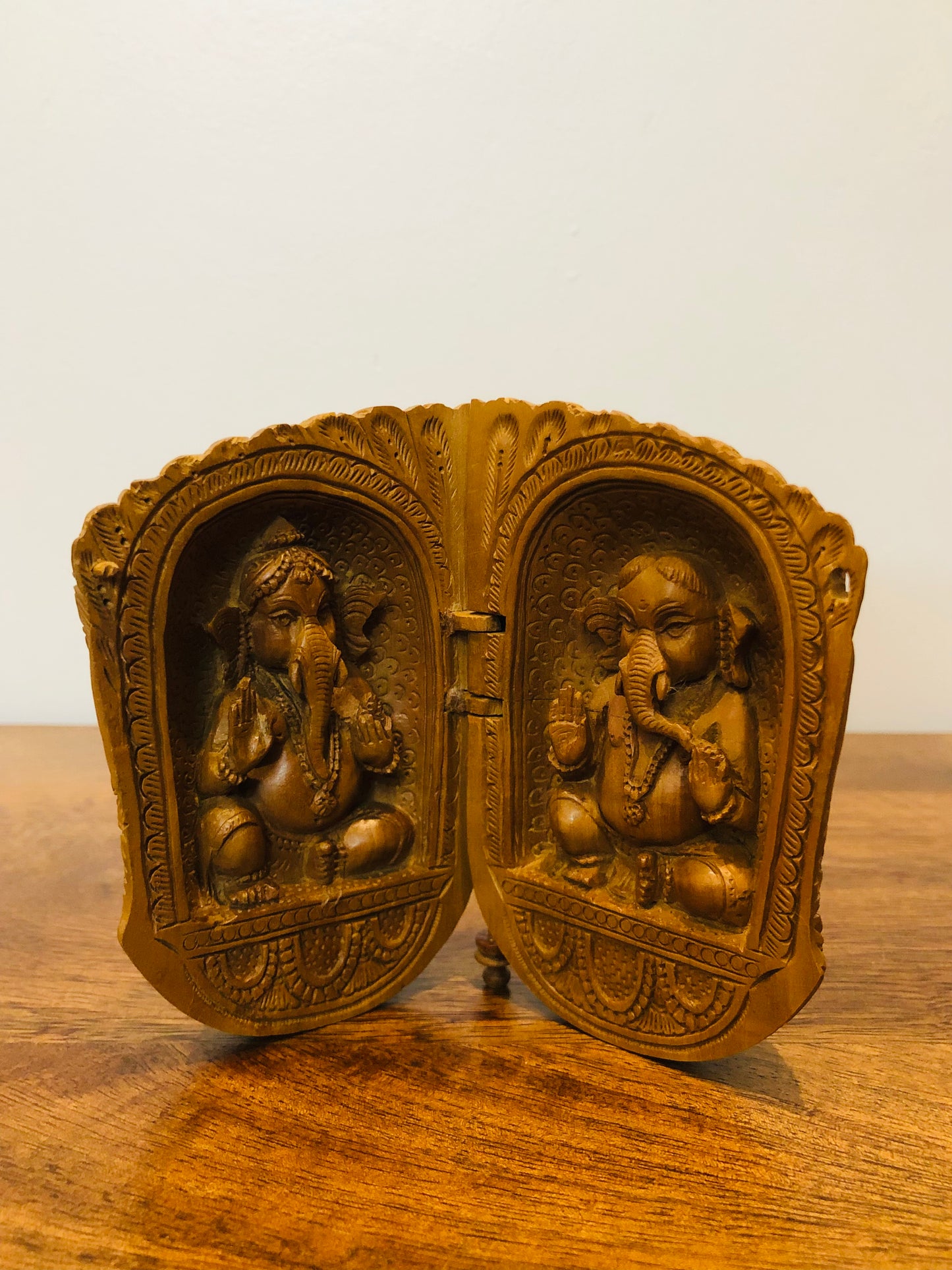 Sandalwood carved god inside shell