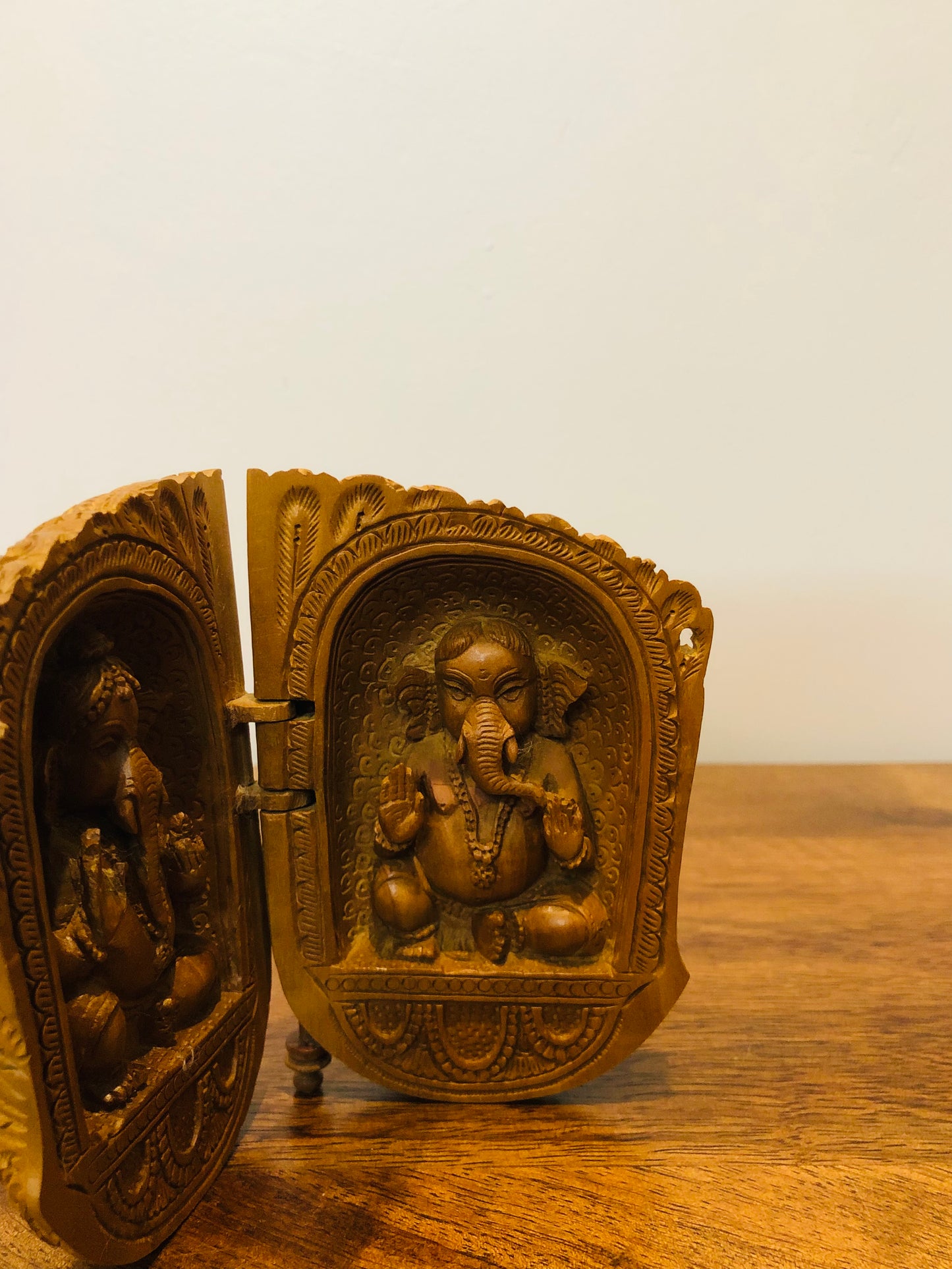 Sandalwood carved god inside shell