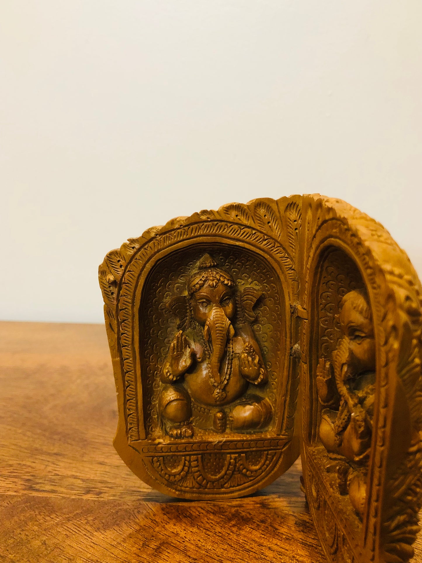 Sandalwood carved god inside shell