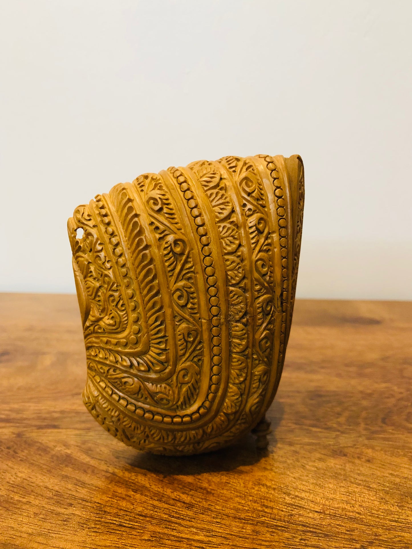 Sandalwood carved god inside shell