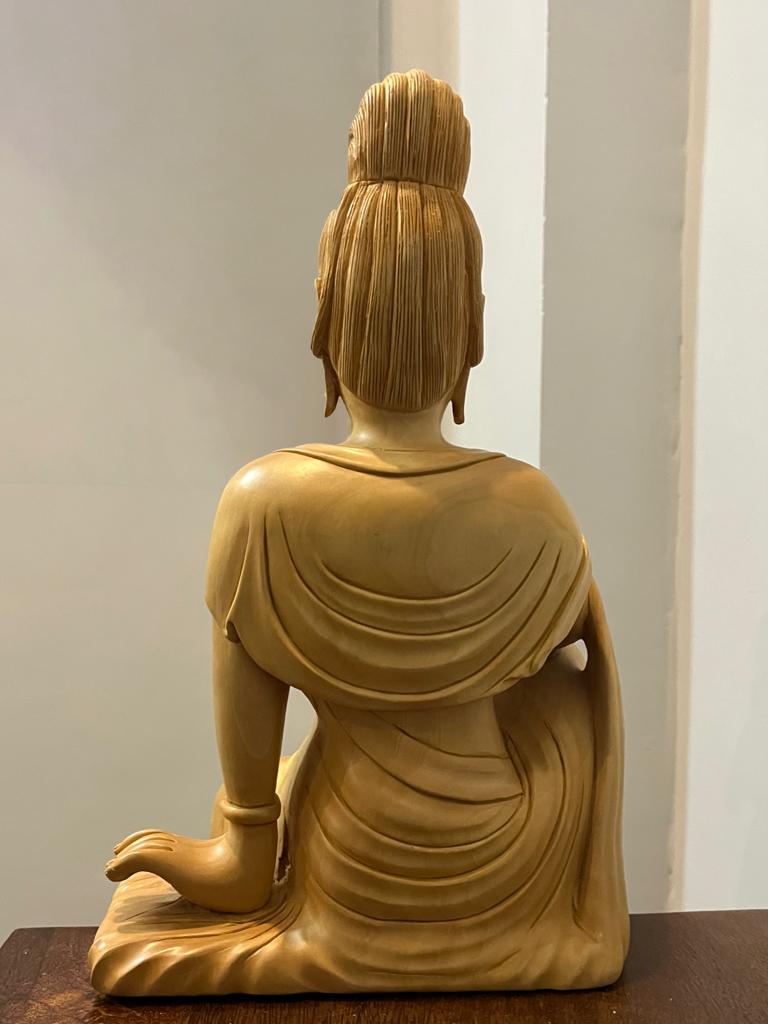 Wooden hand carved collective buddha sitting