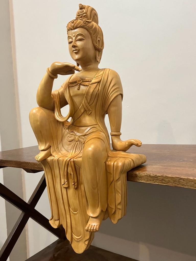 Wooden hand carved collective buddha sitting