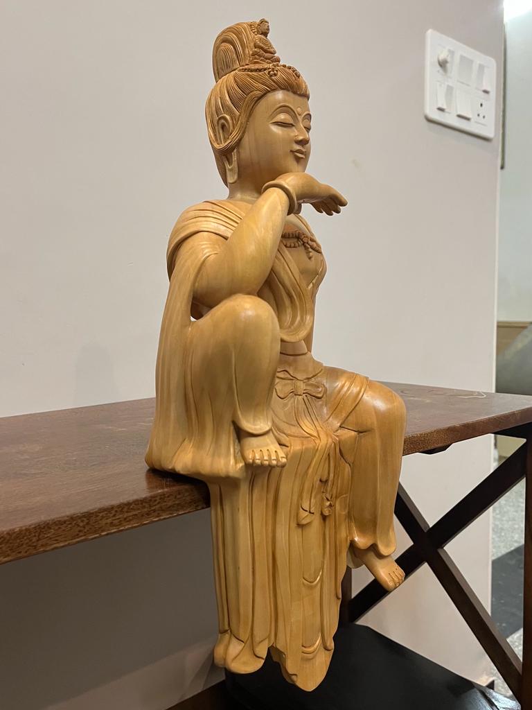 Wooden hand carved collective buddha sitting