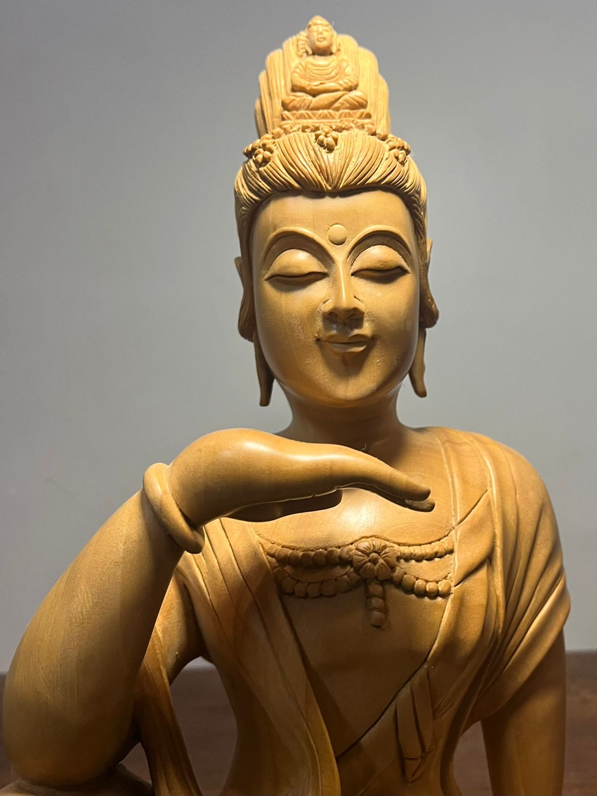 Wooden hand carved collective buddha sitting