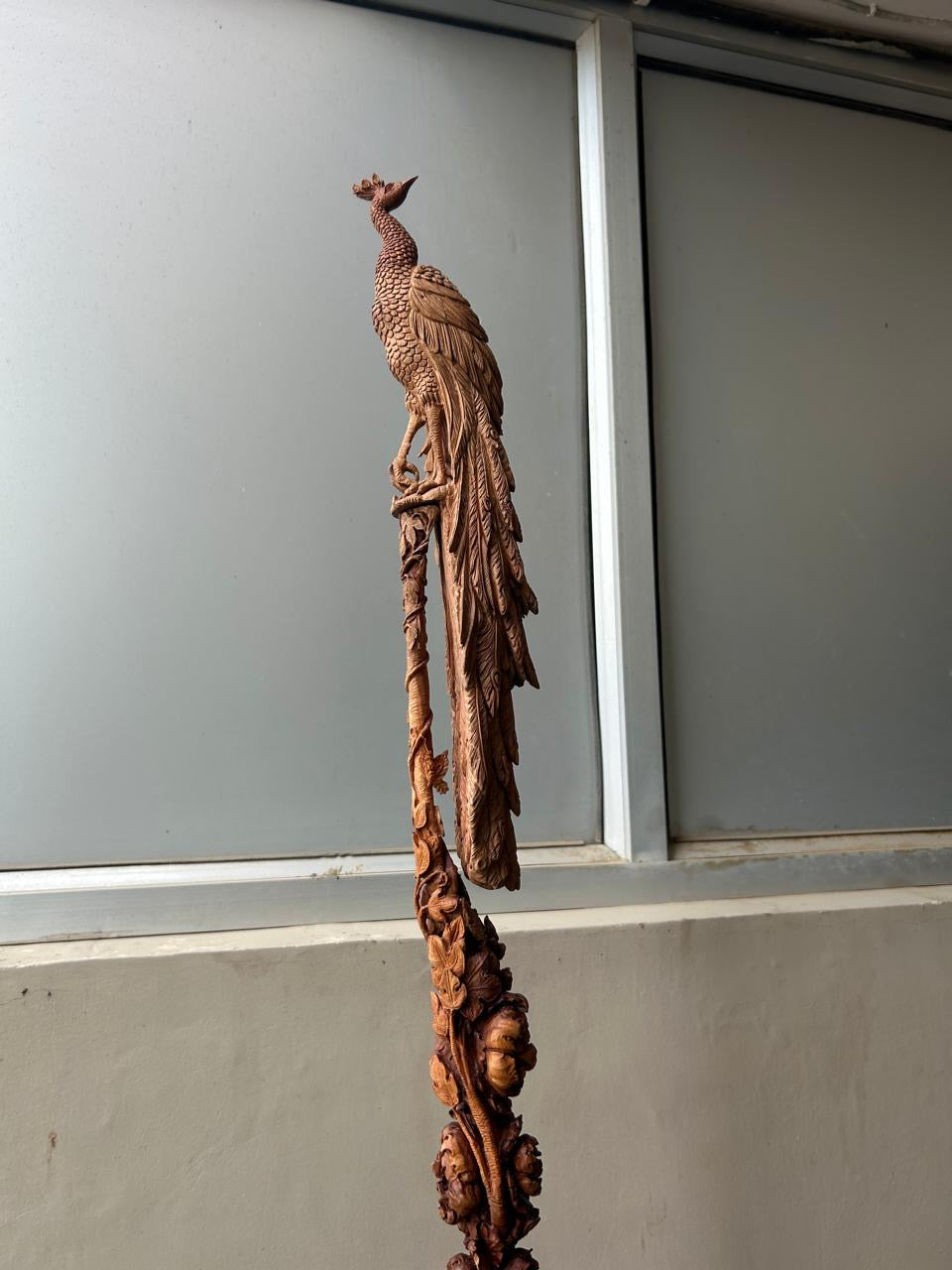 Sandalwood peacock with stick