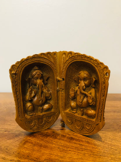 Sandalwood carved god inside shell