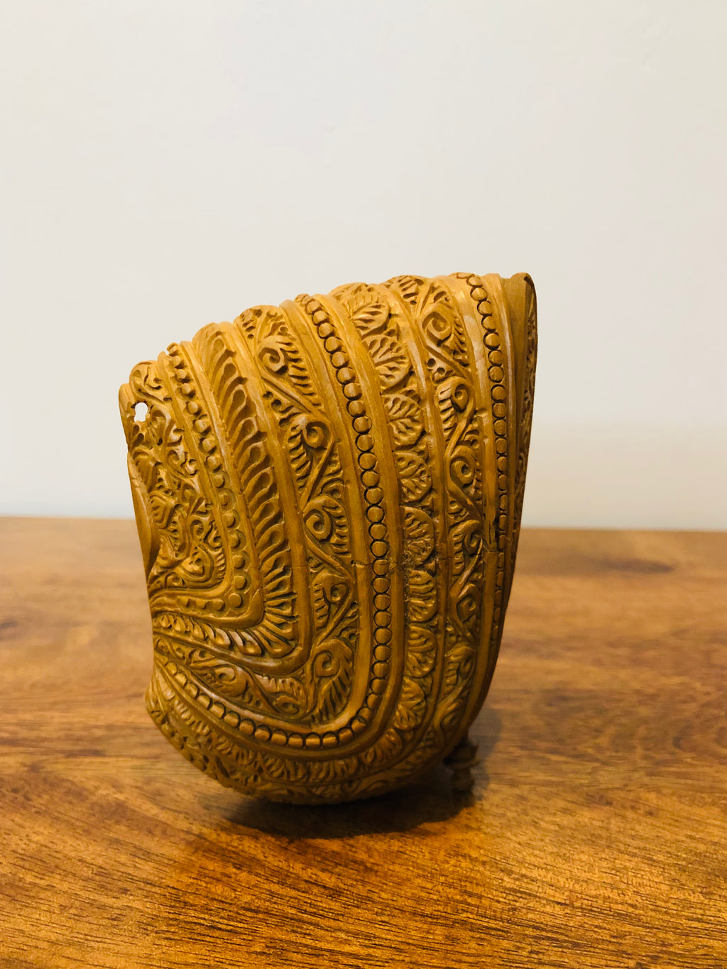 Sandalwood carved god inside shell